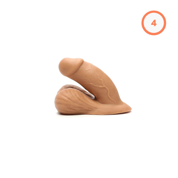 A flesh-colored #1 Trans Packer 4 " silicone packer with detailed realistic styling, shown in a bent position, with an orange number 4 for the bulge rating in the top right corner.