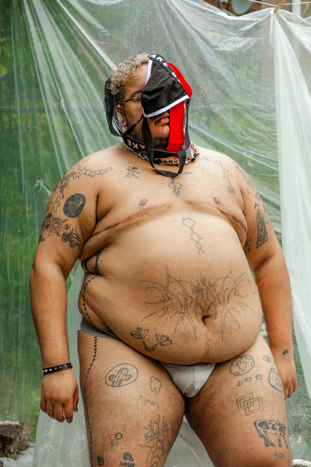 Non-Binary trans person wearing a Cake Bandit Jockstraps as headgear outdoors