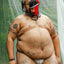 poc trans masc non-binary person wearing a grey cake bandit jocks strap and a black and a red jockstrap on their face