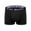 Black 3" packing boxer briefs with 'Cake Bandit' waistband on a white background designed by trans and nobinary people made for everyone.