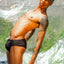 Ziah a black trans man with tattoos wearing the black cake bandit packing swim briefs