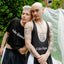 Two people wearing matching black outfits with 'Cake Bandit' branding outdoors.