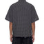 Black and white checkered - Distressed Uhaul button down shirt with frayed edges back view on a person