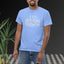 Person wearing a light blue t-shirt with 'I love bottom growth' text, standing against a black background with plants.