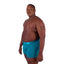 Black person wearing size 2xl aqua color Cake Bandit Monochrome 6" Boxer Briefs against white background